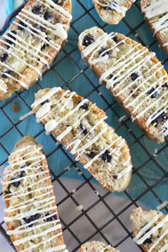 blueberry scones on a cooling rack with icing drizzled over them