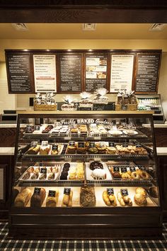 a display case filled with lots of different types of doughnuts and pastries