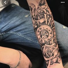 a man's arm with a clock and roses on it