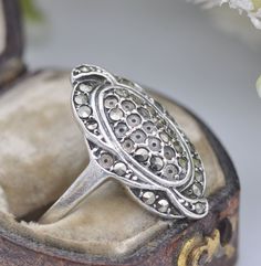 "A lovely vintage 925 sterling silver Art Deco marcasite ring. Stamped on the inside of the band for sterling silver, and stamped \"foreign\", for made outside of England. Please be aware, there are some small marcasite stones missing - please see all the photos. UK Size - L 1/2 US Size - 6 Weight - 3.7 grams --------------------- All boxes in the photographs are for display purposes only, unless stated otherwise. Please be aware there will be marks and wear commensurate with age. Feel free to contact me with any questions." Antique Silver Rings For Anniversary, Vintage Oval Ring With Oxidized Finish, Vintage Sterling Silver Rings With Stone Setting, Vintage Silver Ring With Rose Cut Diamonds, Victorian Silver Rings With Stone Setting, Victorian Silver Ring With Stone Setting, Marcasite Anniversary Rings Stamped 925, Luxury Silver Art Deco Signet Ring, Silver Art Deco Signet Ring With Polished Finish