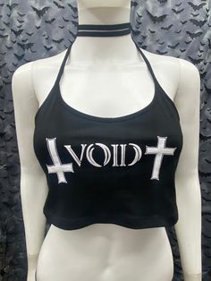 This is a black Void cropped halter top with tie back strings on the neck. They're very long so you can wrap them around the neck for a collared look or just tie back. Scroll thru the photos for different ways of wearing. This has a Void logo image screen printed on the front. 95% Cotton/ 5% Spandex These are handmade screen-printed and may slightly vary from the photo. Please feel free to email me any questions. Thanks for looking. Due to an influx of incorrect addresses if a package is returne Edgy Fitted Halter Top For Festival, Edgy Stretch Crop Top, Stretch Punk Crop Top For Streetwear, Gothic Crop Top For Festivals, Trendy Cropped Halter Top For Club, Gothic Stretch Crop Top, Black Edgy Halter Top For Festivals, Gothic Stretch Cropped Crop Top, Cropped Halter Top For Summer Clubbing