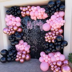 a door decorated with pink and black balloons