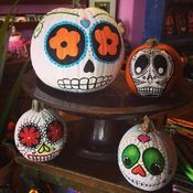 three decorated pumpkins sitting on top of a table