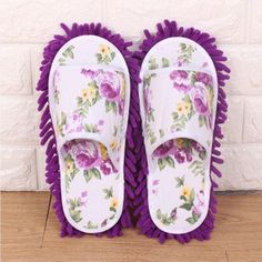 pair of slippers with purple flowers on them