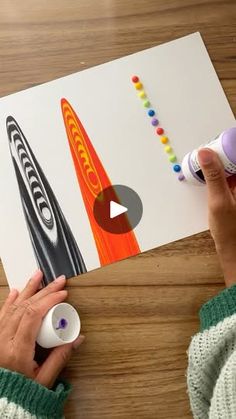 a person is using crayons to make an art project for their child's artwork