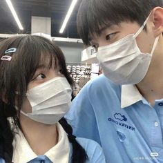 two people wearing face masks in a store