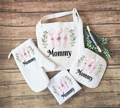 three personalized oven mitts, one for mom and the other for mommy with flowers on them