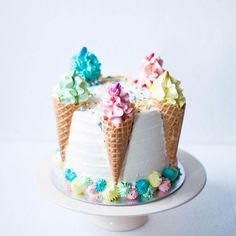 an ice cream cake decorated with flowers and cones