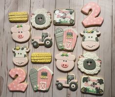 decorated cookies with farm animals and tractors are arranged in the shape of numbers 2 - 3