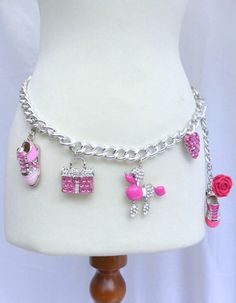 Shocking Pink Rhinestone and Glitter Charm Belli Belt with Sneakers, Pink Kelly Bag, Pink Poodle, Pink Encrusted Heart and Flower. This adjustable chain belt which sits right at the hip is made with big silver curb links  which are interwoven with Baby Pink Suede ribbon. Embellished with dangling Rhinestone and metal charms, including 2 Sneakers, Pink Kelly Bag, Pink Poodle, Pink Encrusted Heart and Flower.Total Charms. (6) The belt is adjustable and closes with a hook depending upon the desired Pink Kelly Bag, Casetify Iphone Case, Pink Kelly, Bling Gifts, Pink Poodle, Shocking Pink, Sneakers Pink, Doll Jewelry, Kawaii Accessories