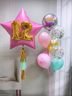 balloons and streamers in the shape of stars are on display at a 21st birthday party