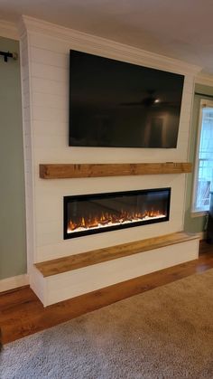 a television mounted on the wall above a fireplace