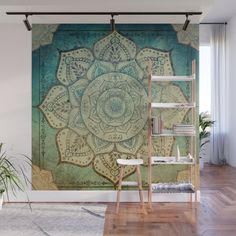 a green and blue wall mural with a flower design on the front in a living room