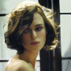 a close up of a woman with short hair