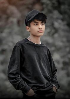 a young boy wearing a black baseball cap