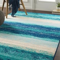 a blue and white rug in a living room