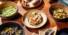 a table topped with lots of different types of food and bowls on top of it