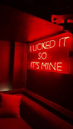 a red neon sign that says i liked it so it's mine on the wall