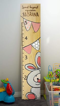 a tall wooden ruler with an image of a rabbit on it