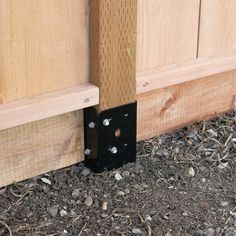 a close up of a wooden door frame with screws on the bottom and side