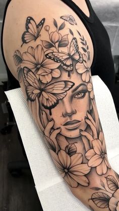 a woman's face with flowers and butterflies on her arm