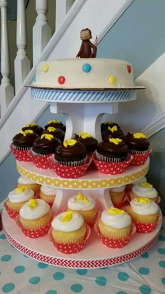 cupcakes are stacked on top of each other in front of a cake stand