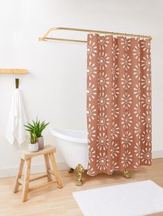 a white bath tub sitting next to a wooden stool in front of a shower curtain