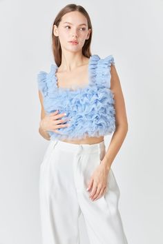 This Ruffled Shoulder Strap Tulle Top will add a bit of class and sass to your wardrobe. Featuring a cropped length sleeveless top and delicate ruffled shoulder straps it's the perfect addition to any outfit. Add it to a skirt or dress or simply style it with jeans and heels. Cropped length Ruffled shoulder straps Sleeveless Lined Hand wash cold Do not bleach Do not tumble dry Iron low Shell: 100% Polyester Lining: 90% Polyester 10% Spandex Exclusive of Elastic JJ2152T Total length: 15.5" Bust: Chic Cropped Ruffle Crop Top, Elegant Ruffled Crop Top For Spring, Cropped Ruffled Party Tops, Cropped Ruffle Tops For Party, Feminine Ruffled Crop Top, Feminine Ruffled Crop Top With Ruffled Straps, Feminine Ruffled Straps Crop Top, Feminine Sleeveless Ruffled Crop Top, Feminine Sleeveless Ruffle Crop Top