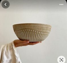 a person holding a bowl in their hand