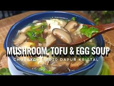 mushroom, tofu and egg soup in a blue bowl