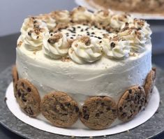 a cake with cookies and cream frosting on it sitting on a table next to another cake