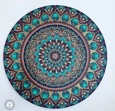 a blue and brown circular design on a white wall