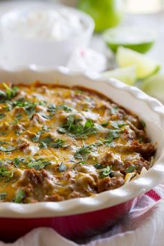 a casserole dish with meat, cheese and herbs