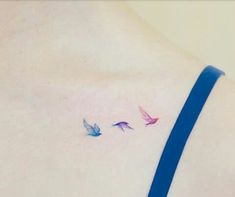 three small birds on the back of a woman's left side ribcage