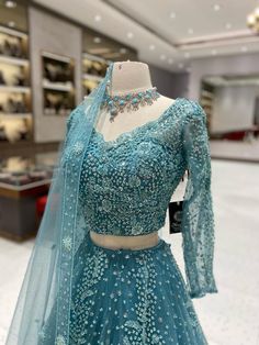 Get ready to rock your wedding day with our Teal Blue Bridal Lehenga BL-102. This stunning lehenga features a gorgeous teal blue color that will make you stand out as you walk down the aisle. With intricate embroidery and elegant design, this lehenga is perfect for a bride who wants to make a statement. (Sorry, tiara not included!) Fabric: Net with Satin Silk Lining! WASH CARE INSTRUCTIONS - Please Dry clean only when it is applicable! Ready to Ship! Blue Sharara With Traditional Drape For Reception, Light Blue Anarkali Wedding Gown, Light Blue Anarkali Gown For Wedding, Light Blue Anarkali Set For Reception, Wedding Anarkali Gown In Light Blue, Wedding Light Blue Anarkali Set With Resham Embroidery, Anarkali Light Blue Gown For Wedding, Traditional Blue Gown For Wedding, Festive Light Blue Lehenga With Intricate Embroidery