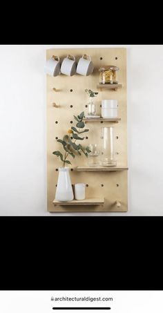 a wooden shelf with vases and cups on it