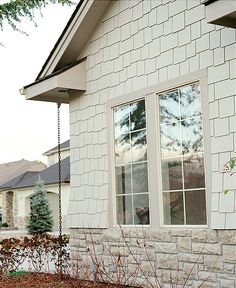 a white brick house with two windows