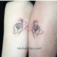 two people with tattoos on their arms pointing at each other's fingers and the words love