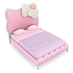 a pink and white bed with a hello kitty headboard on it's side