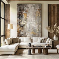 a living room filled with furniture and a large painting on the wall