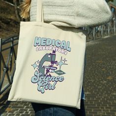 a woman carrying a tote bag that says medical laboratory science girl on the front