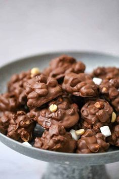 a bowl filled with chocolate covered cookies on top of a table