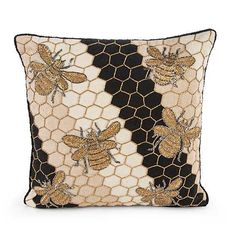 a black and white pillow with bees on it