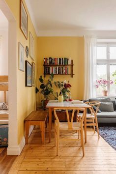 a living room filled with furniture and yellow walls