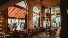 the inside of a restaurant with tables and chairs