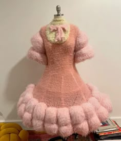 a pink dress is sitting on top of a table