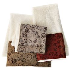 three towels are stacked on top of each other in different colors and patterns, with one folded up to the side