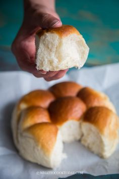 a person holding a piece of bread in their hand