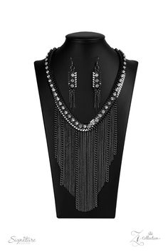 a necklace and earring set is shown on a mannequin with chains hanging from it