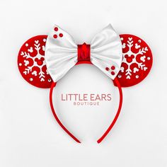 a red and white minnie mouse ears with snowflakes on it